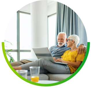 older couple on couch enjoying fiber internet to surf online