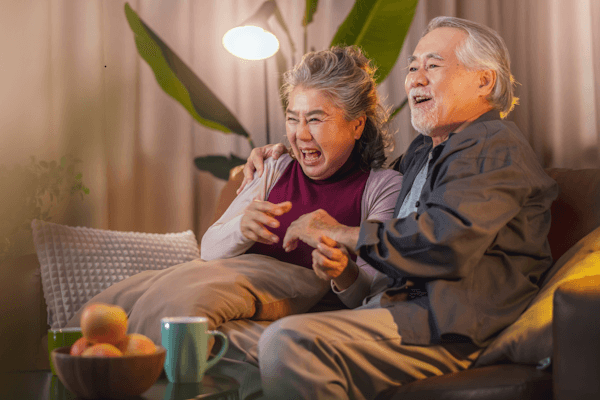 Blog couple laughing on couch